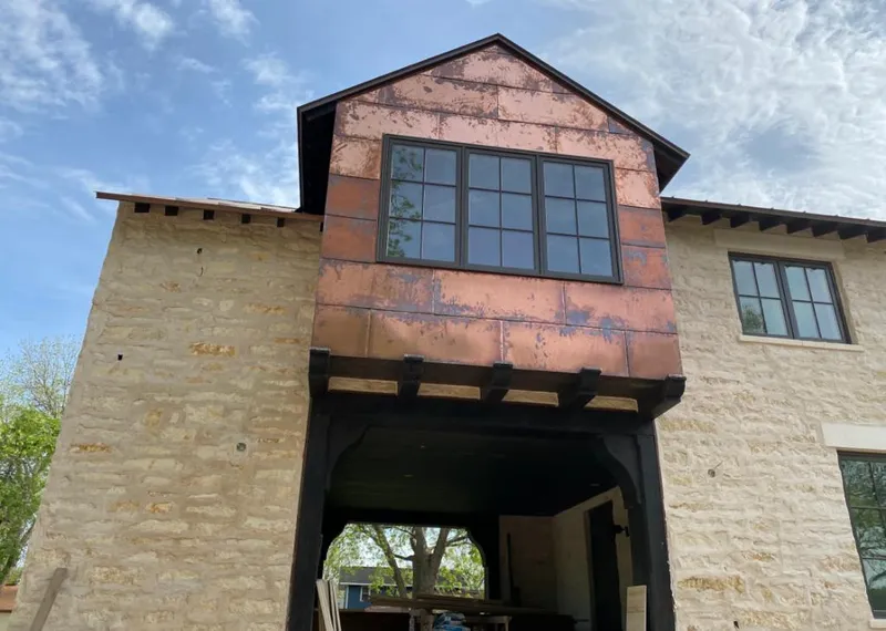 Copper metal panel facade on a stone building for Skylight Installation in Williamson